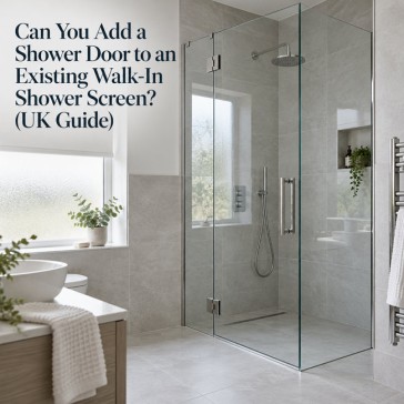 Walk-in shower screen with a newly added frameless hinged glass door in a modern UK bathroom