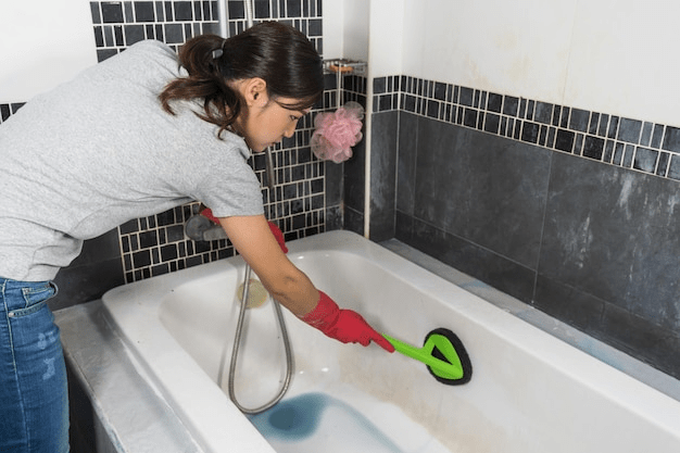 women cleaning bath with bath cleaner
